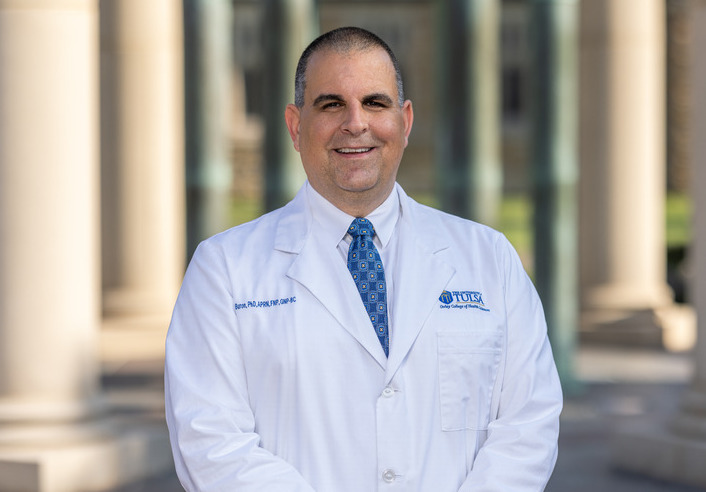 Bill Buron, UTulsa professor and American Academy of Nursing Fellow smiling for a portrait