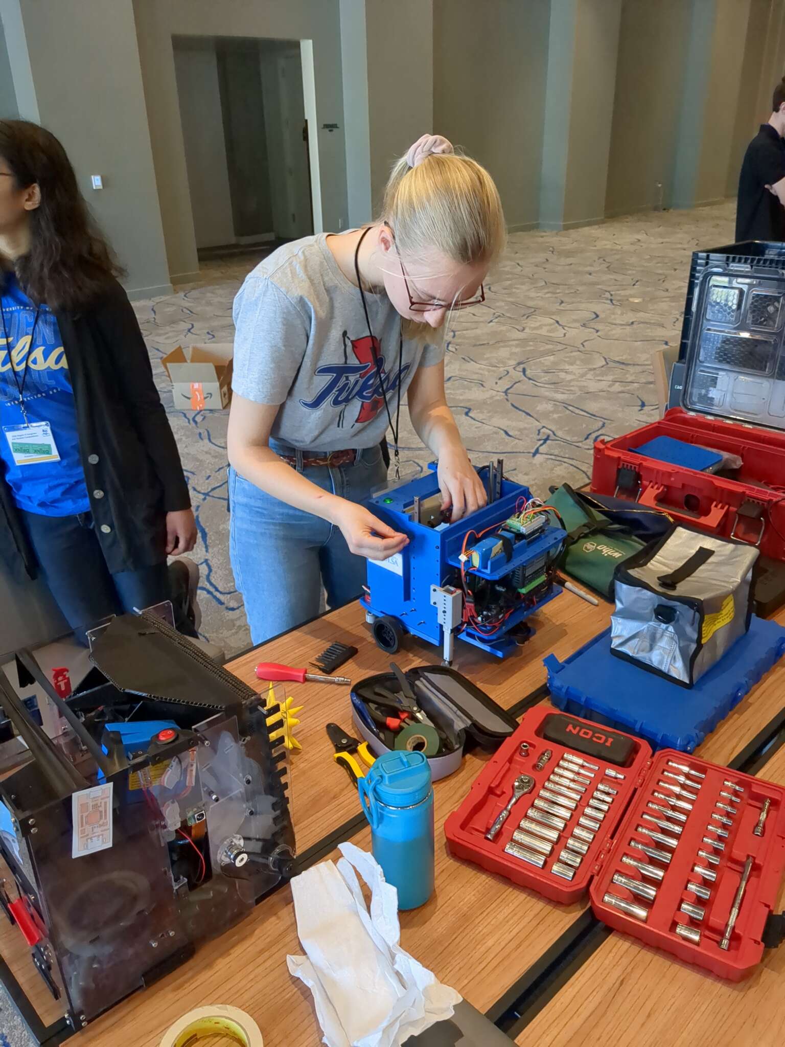 UTulsa robotics team members work on robot