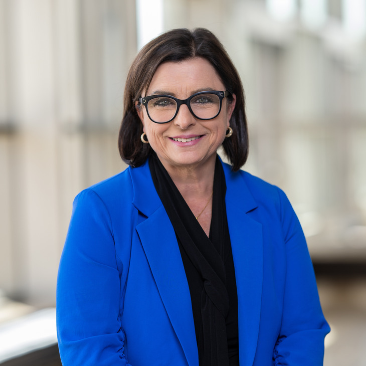 Woman in blue blazer smiling