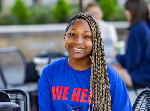 Student smiling in blue shirt