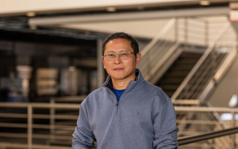 Researcher in grey quarter-zip