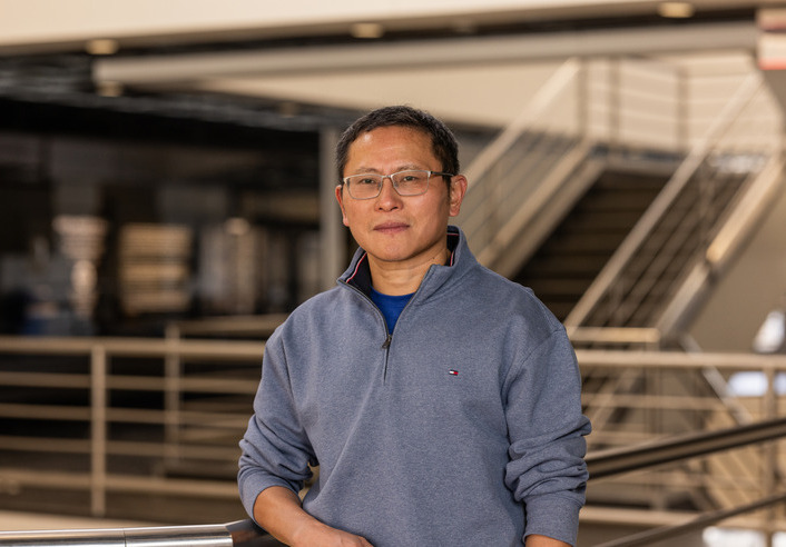 Researcher in grey quarter-zip