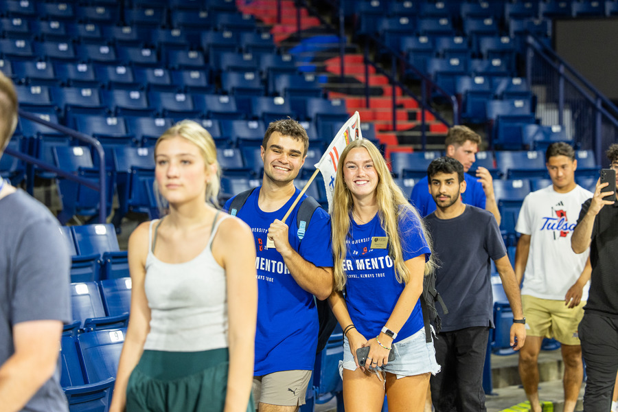 Students in blue shirts at orientation