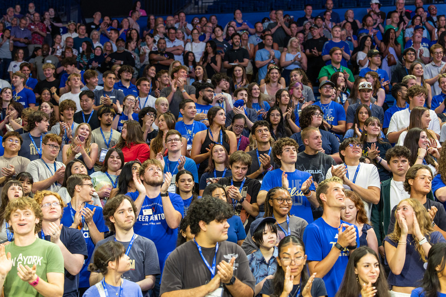 Students in blue shirts at orientation