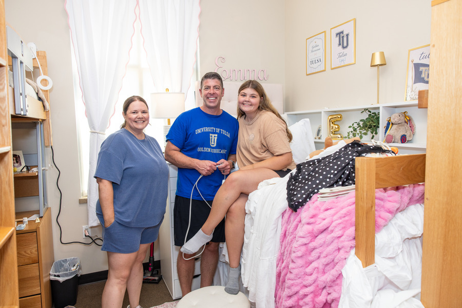 Family poses in dorm room