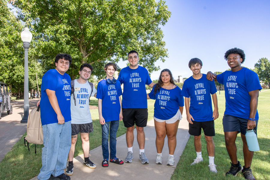 Students in blue shirts at orientation
