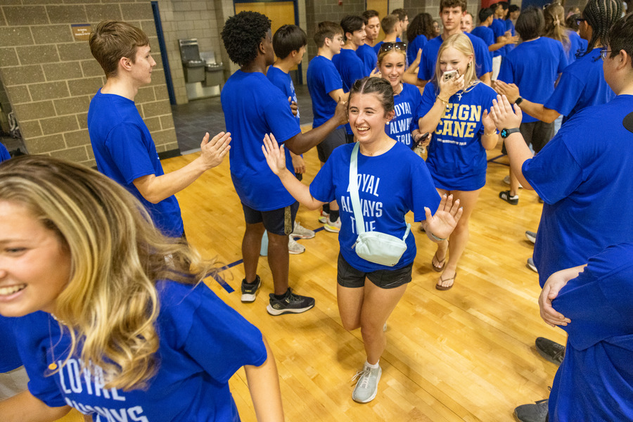 Students in blue shirts at orientation