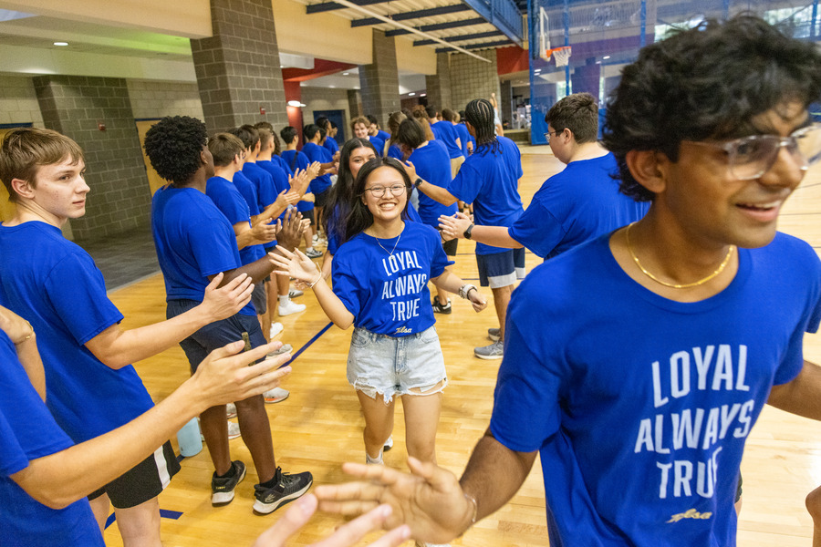 Students in blue shirts at orientation