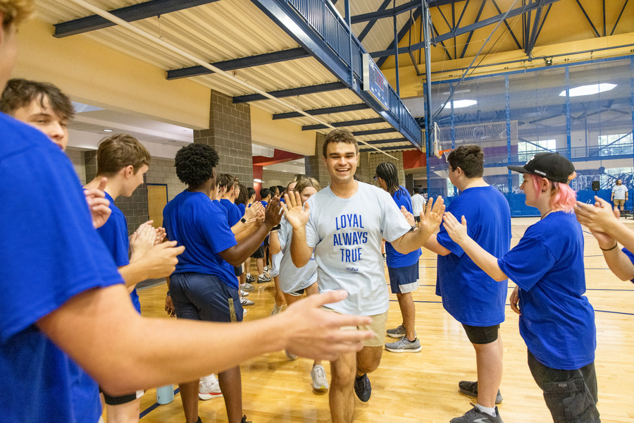 Students in blue shirts at orientation