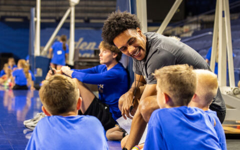 Coach interacting with young athletes