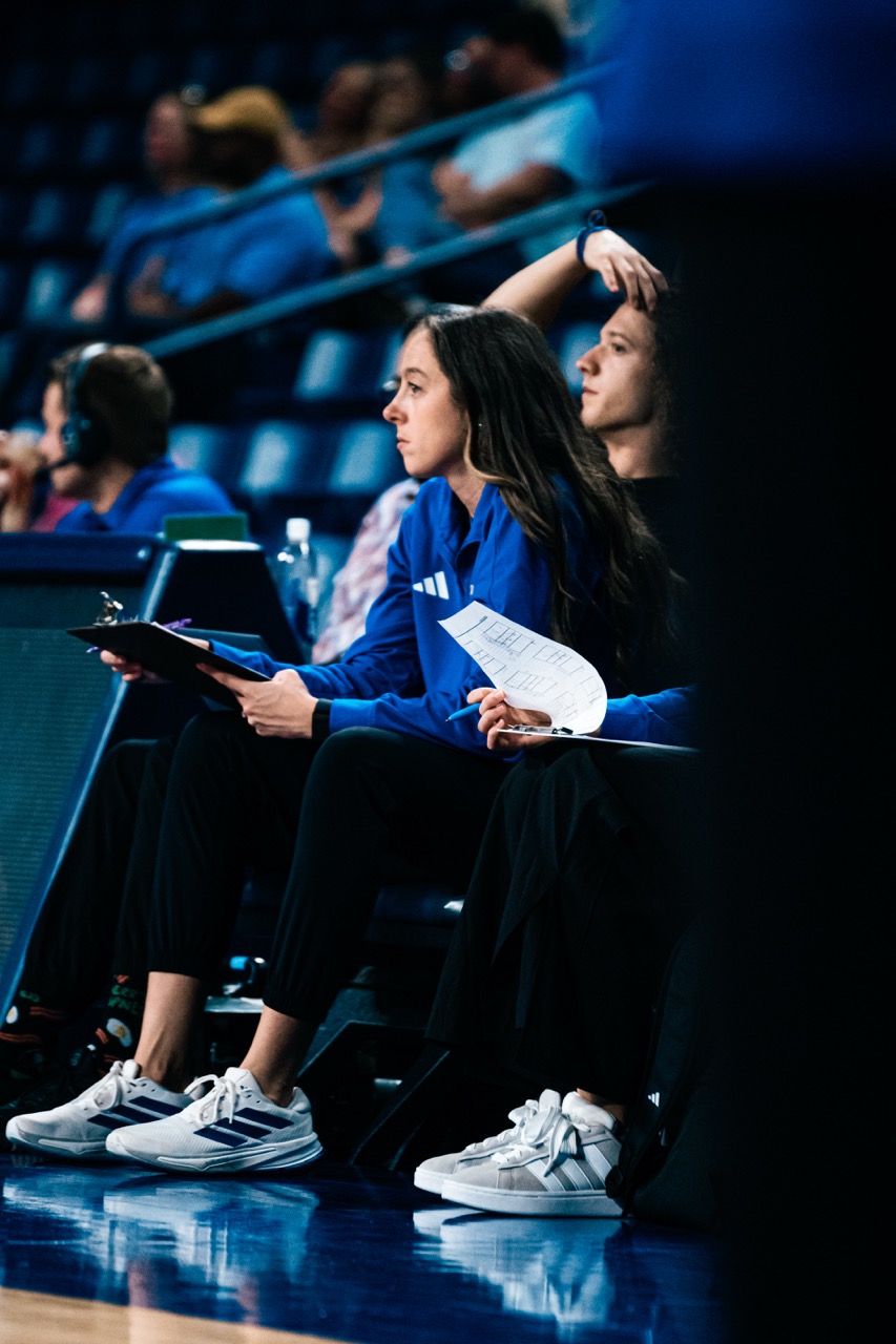 Coaches watching basketball game