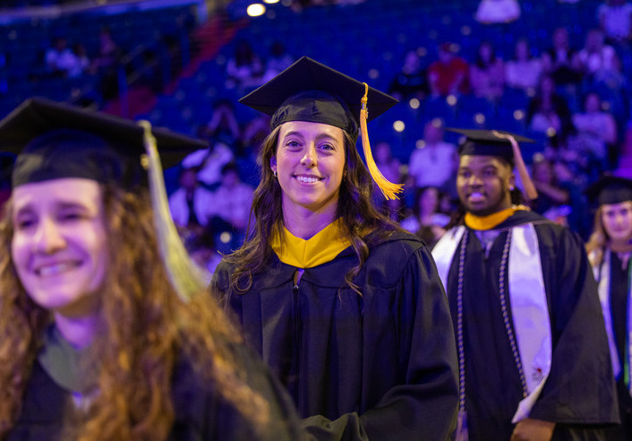 Graduates in caps and gowns smiling