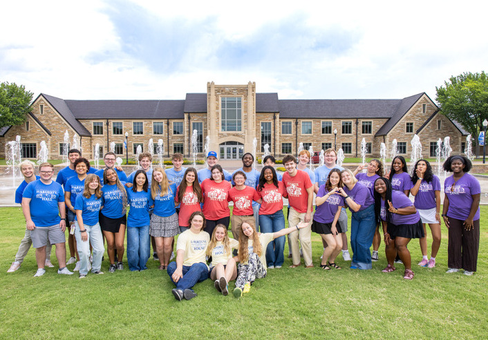 UTulsa students pose in front of building