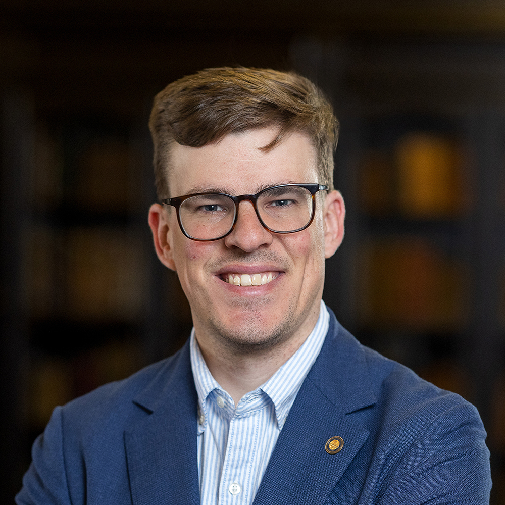 Man in blue suit and glasses