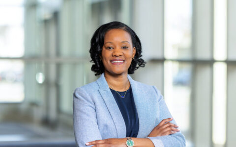 Woman with arms crossed in blue blazer