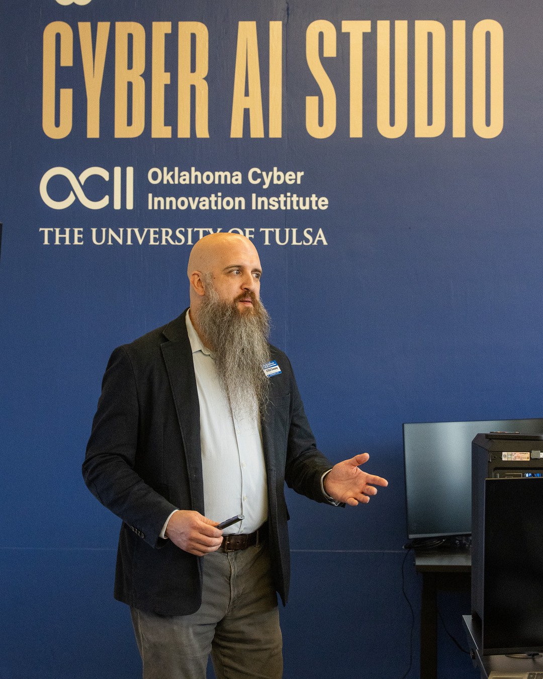 Man with beard speaks at Cyber AI Studio
