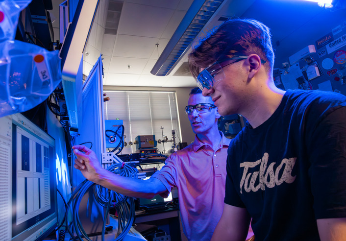 Students in lab discussing data on screen