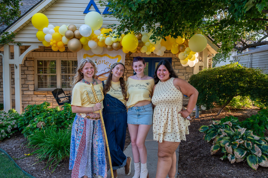 Four young women in yellow shirts at Bid Day