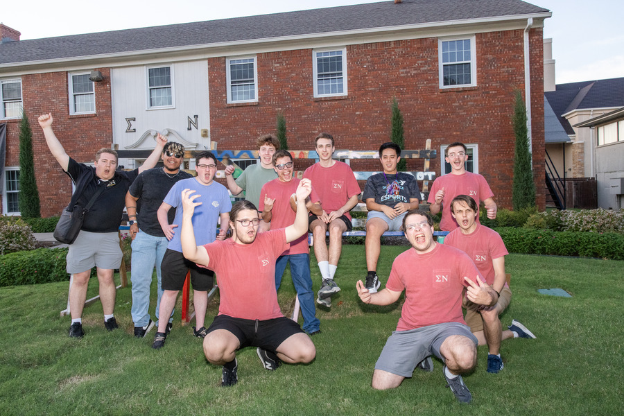 Young men int he Sigma Nu house pose on Bid Day 2026