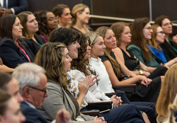 Women listen intently in a lecture hall