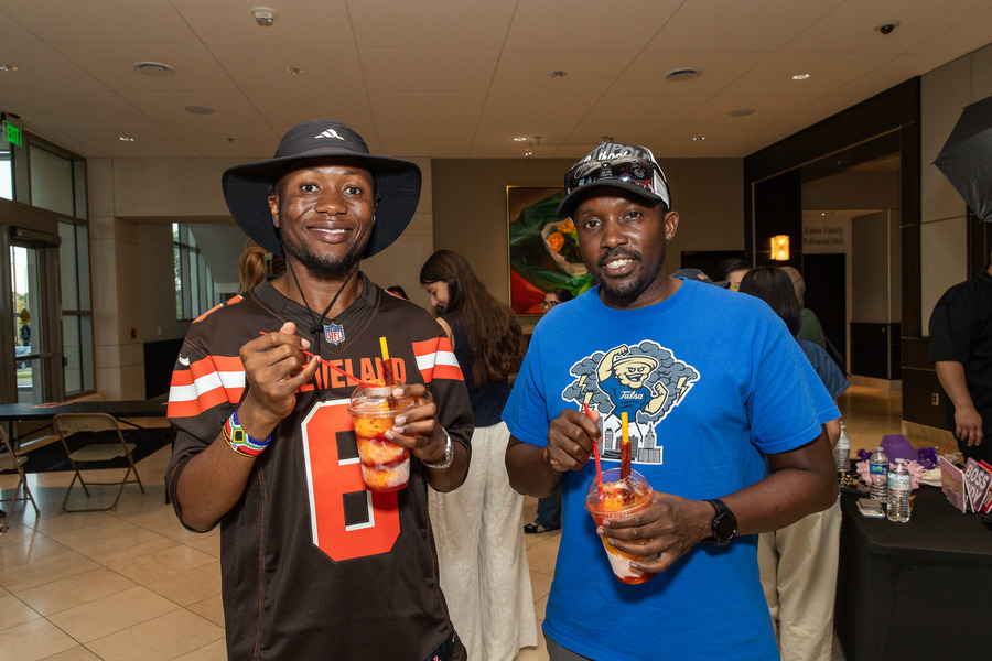 Two men holding drinks at Festival de las Flores