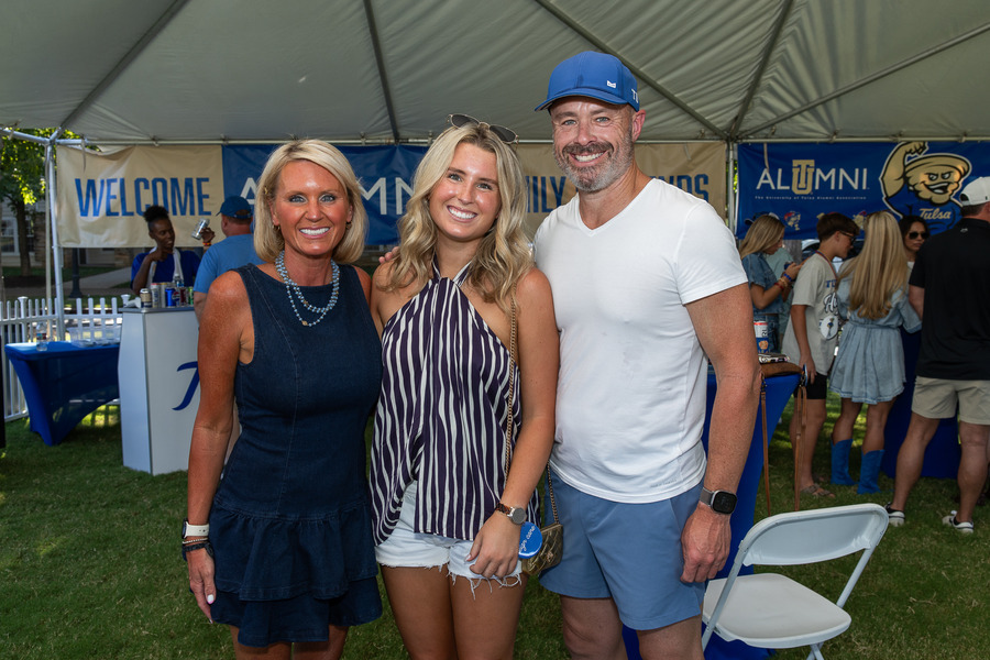 A UTulsa student with her parents at Parent & Family Weekend tailgate