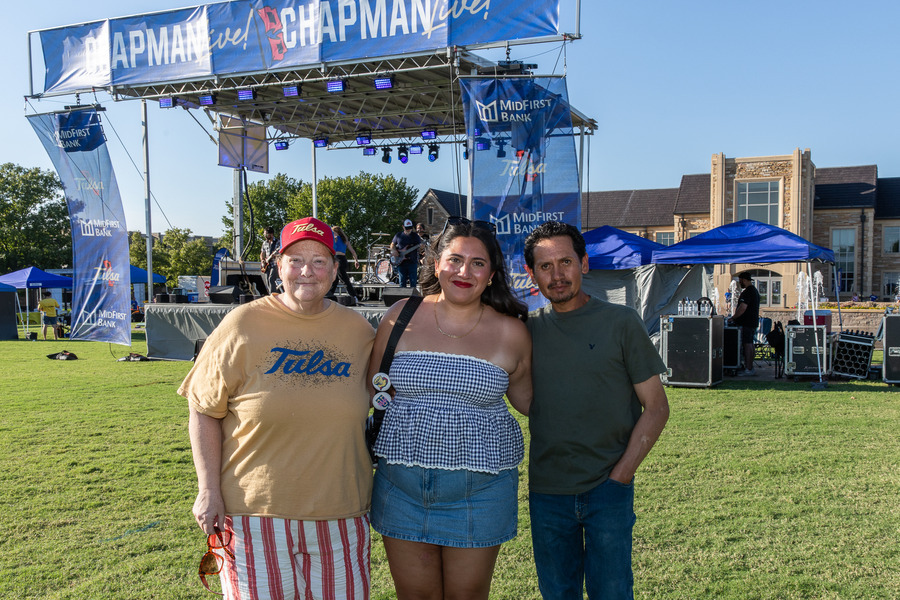 Three people at outdoor music event