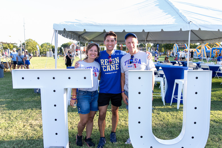 Family poses with TU letters at Parent & Family Weekend