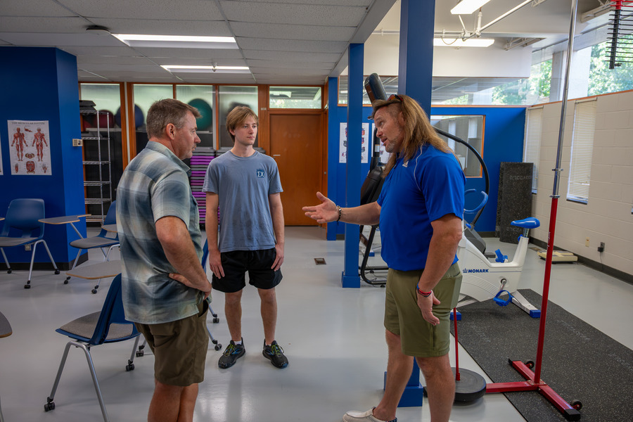 Men talking in a classroom