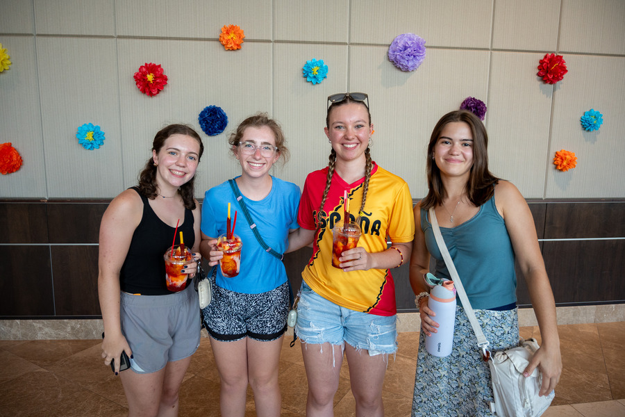 Four young women holding drinks at Festival de las Flores