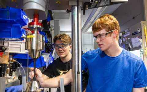 Students work on research equipment