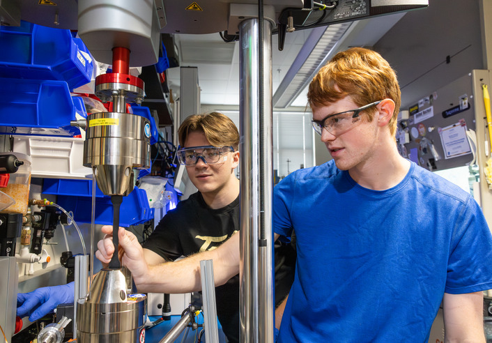 Students work on research equipment
