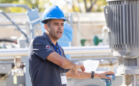 Photograph of Eduardo Pereyra lecturing in front of pipelines at UTulsa's North Campus