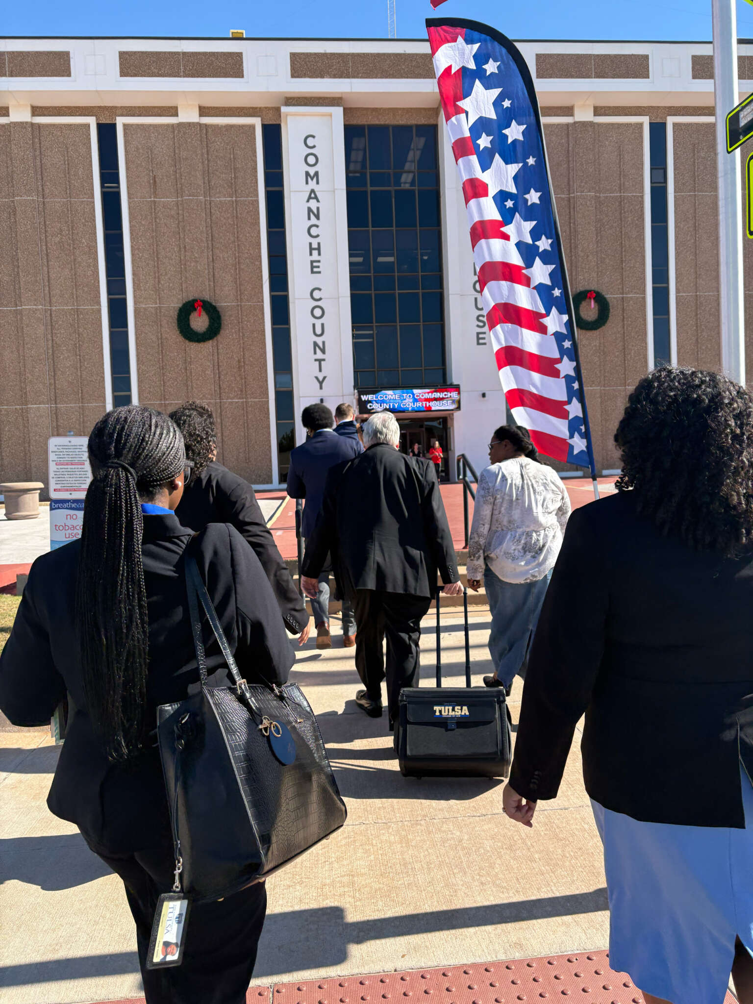 People entering Comanche County Courthouse