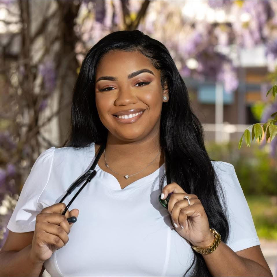 Young woman in scrubs with stethoscope